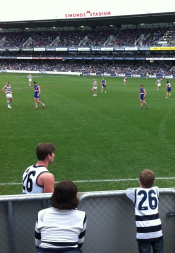 2012 ROUND 22 TOM HAWKINS PREPARES TO SHOOT FOR GOAL IN THE THIRD QUARTER WHILE A YOUNG FAN WATCHES ON