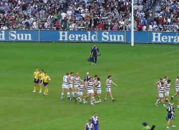 CATS CELEBRATE CAMERON MOONEY'S FIFTH GOAL, AFTER THE SIREN, ON THREE QUARTER TIME