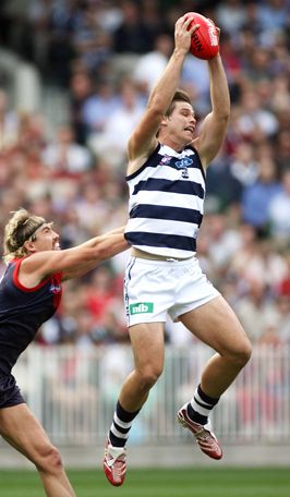 TOM HAWKINS MARKS STRONGLY IN FRONT OF HIS MELBOURNE OPPONANT 'CHOPPER' CARROL
